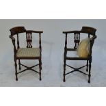 A pair of Edwardian mahogany and inlaid corner chairs with ring turned stretchered supports,