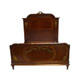 A reproduction Empire style queen size bedstead with parquetry inlay to the head and footboards,