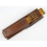 A late 19th century leather cased set of boxwood and brass mounted Customs and Excise alcohol