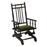 A child's oak American platform rocker with turned spindles.