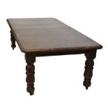 An early 20th century oak acanthus leaf carved extending dining table,