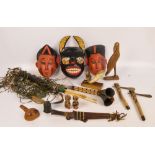 A collection of 20th century ethnic artifacts including masks, decorative quiver with arrows,