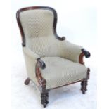 An early Victorian rosewood spoon back chair with padded back, arms and seat,