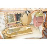 Three variously shaped gilt framed mirrors,