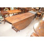 A reproduction oak wake table with twin oval flaps,