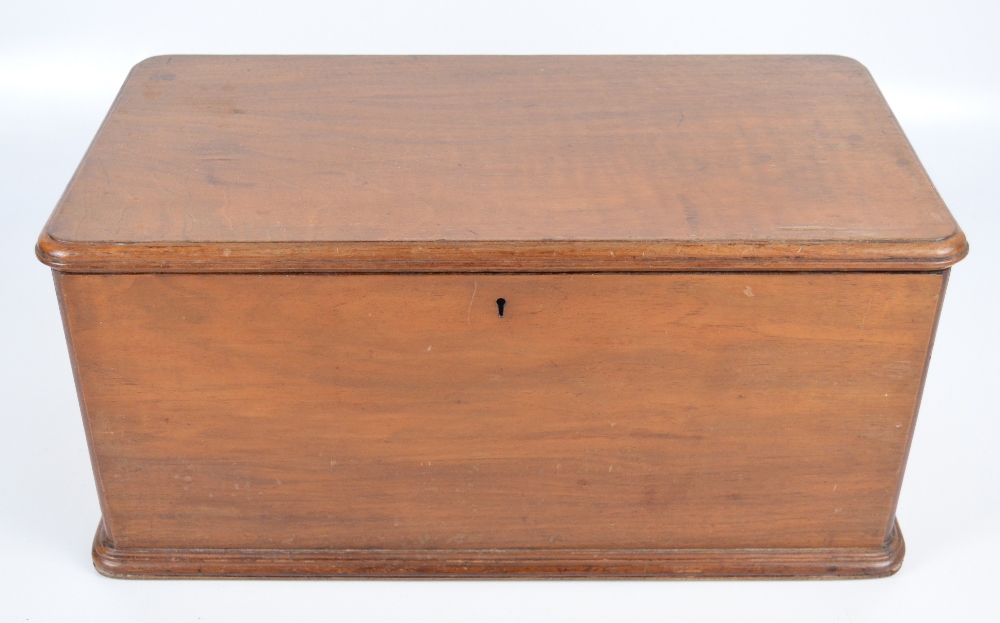 A c.1900 walnut rounded rectangular lidded box with compartmentalised interior, width 50cm.