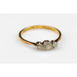 An 18ct yellow gold three stone diamond ring with claw setting, the central stone approx 0.