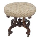 A Victorian walnut button upholstered circular stool on four S-scroll legs with united by