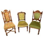 A pair of Victorian walnut framed upholstered chairs with foliate carved shield shaped backs,