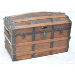 A domed leather covered metal and wood bound trunk with twin handles, 91 x 47.5 x 58cm.