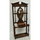 A late Victorian carved oak hall stand,