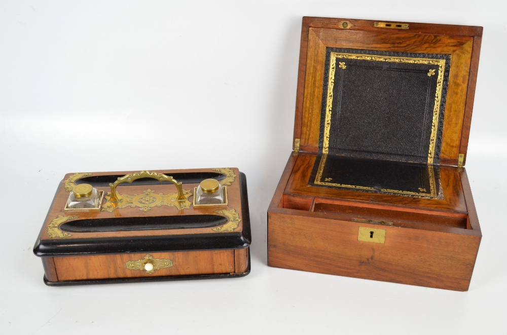 A late Victorian mahogany writing slope with inset brass vacant cartouche to the lid enclosing