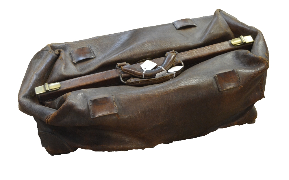 A large vintage brown leather Gladstone bag with double handles and clip fastening, width 62cm.