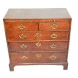 A George III oak chest of small proportions, the simple rectangular top above brushing slide,