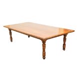 A large oak plank top dining table raised on ring turned and block supports, length 275cm.