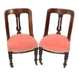 A set of six Victorian mahogany dining chairs on turned supports.