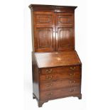 A late 18th century oak and mahogany crossbanded bureau bookcase,