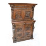 A late 19th century Flemish carved oak side cabinet with two upper doors enclosing drawers above