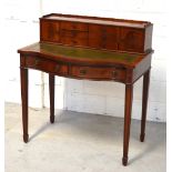 A reproduction mahogany bonheur du jour on tapering square section legs, green leather inset top,