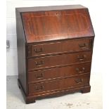 A reproduction four-drawer mahogany bureau on bracket feet, width 75cm.