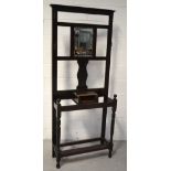 An early 20th century hallstand with central rectangular bevel edge mirror, width 82cm (af).