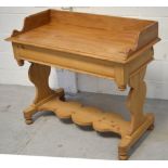 A pine wash stand, gallery back, shaped side supports and lower shelf, length 106cm.