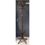 A mahogany bentwood-style coat stand with integral umbrella stand, height 198cm.