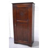 A single door 'Magnum' oak wardrobe with fitted interior, raised on bracket feet, width 94cm.