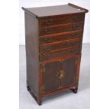 A contemporary Korean elm side cabinet with five drawers above two cupboard doors,