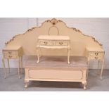 A French-style cream bedroom suite comprising a headboard with built-in two-drawer cabinets,