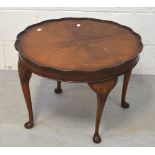 A mid-20th century walnut coffee table on cabriole legs, diameter 60cm.