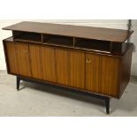 A vintage G-Plan sideboard on stylised ebonised tapering supports, width 149cm.