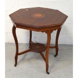 A 20th century mahogany inlaid octagonal table on curving tapering supports with lower octagonal