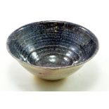 DEREK DAVIS (1926-2008); a small stoneware bowl covered in mottled purple and lilac glaze,