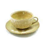 LOWERDOWN POTTERY; a fluted stoneware cup and saucer, impressed L+ mark, cup height 6.5cm.