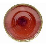 MICHAEL BUCKLAND for Green Dene Pottery; a stoneware dish, copper red glaze to interior,