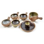 LEACH POTTERY; four small side-handled bowls, a small gravy boat/milk jug,