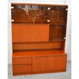 A G-Plan style teak unit with upper glazed doors, width 136cm.