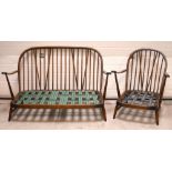 A retro Ercol stick-back two-seater sofa, width 133cm and a matching armchair (2).