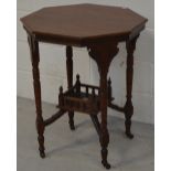 A 19th century octagonal mahogany table with carved and turned supports,