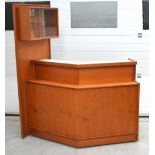 A c1970 corner bar with cupboards to interior for various beverages,