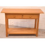 A 20th century oak hall table with two small drawers over lower shelf, length 115cm, depth 41cm.