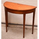 A reproduction inlaid demi-lune table raised on square section tapering legs, width approx 90cm.