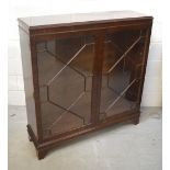 A mahogany twin-door astragal glazed display cabinet on bracket feet, width 107cm.