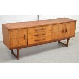 A retro sideboard, three drawers and two cupboard sections, overall raised on conjoining legs,