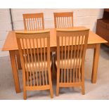 A modern oak extending dining table with integrated leaf,