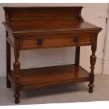 A Victorian oak buffet with single long drawer, lower tier and turned bulbous supports, width 107cm.