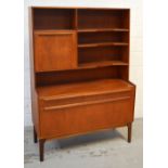 A retro teak unit with fold-down front, overall raised on rounded legs, width 112cm.