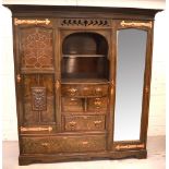 An early 20th century Arts and Crafts style stained pine two-door wardrobe, one mirrored door,