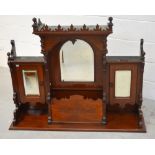 A Victorian mahogany cabinet top with carved frieze over domed shaped mirror and two mirrored